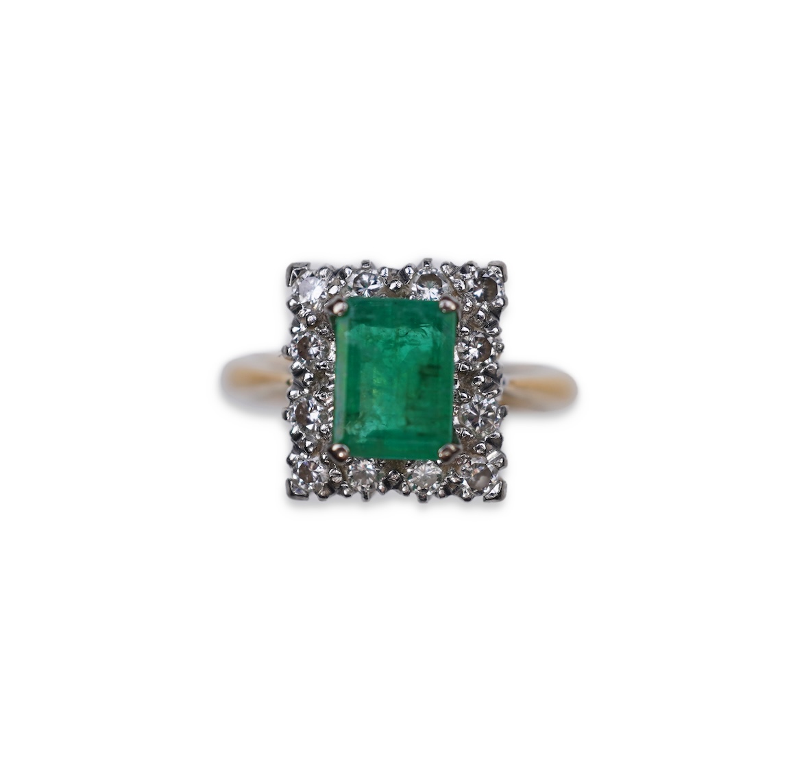 An emerald and diamond ring